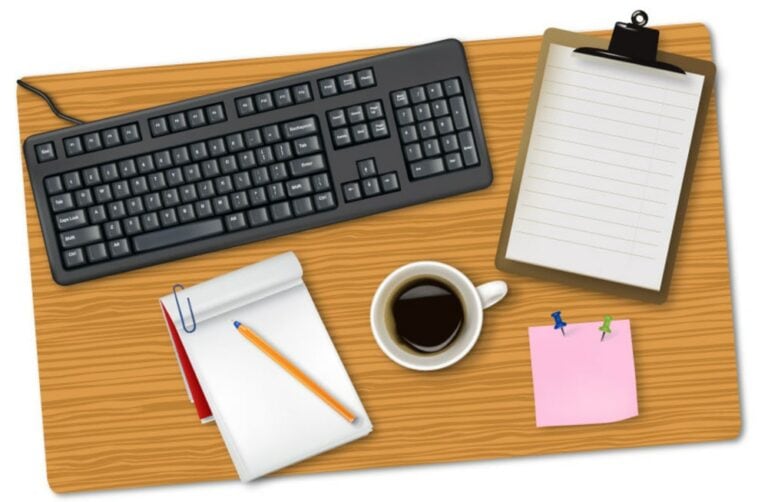 Keyboard, notepad, and coffee cup