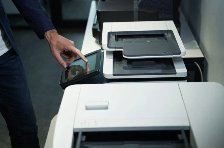 , such as an HP LaserJet Enterprise or similar all-in-one office machine, while interacting with its integrated touchscreen control panel.