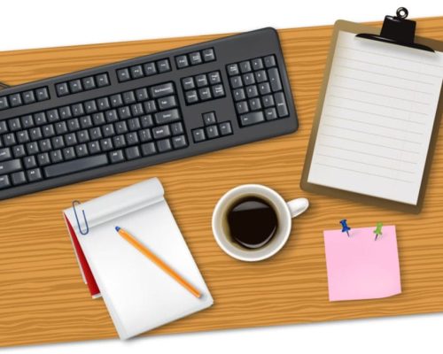 Keyboard, notepad, and coffee cup