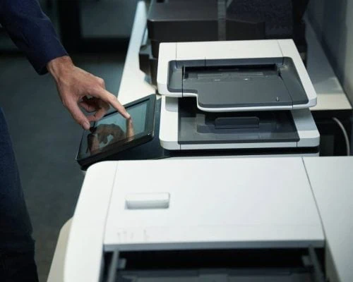Screenshot 2026-10-21 at 7.38.30 PM , such as an HP LaserJet Enterprise or similar all-in-one office machine, while interacting with its integrated touchscreen control panel.