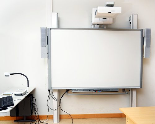 Students entering a modern school equipped with upgraded security systems, classroom technology, and managed IT infrastructure.