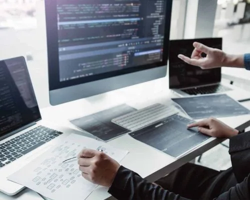 team-working-development-of-programming-and-encryp-2023-11-27-05-34-40-utc Software as a Service - programming team in front of three computers