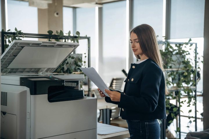 Office employee operating a multifunction printer