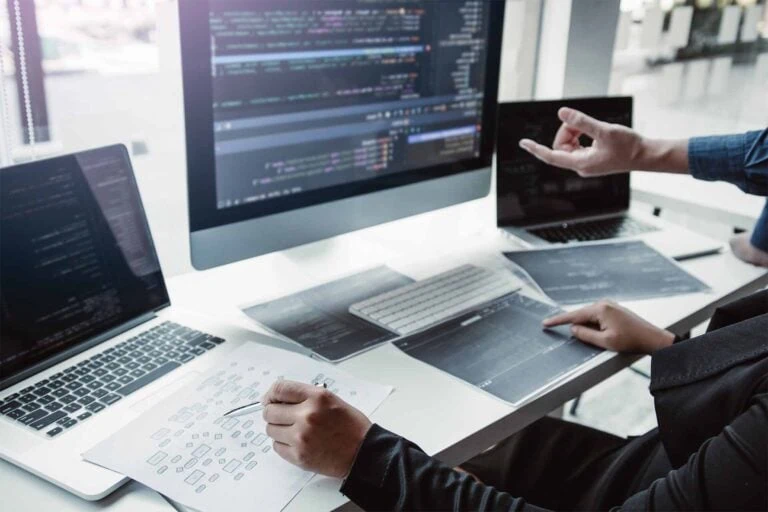 Software as a Service - programming team in front of three computers